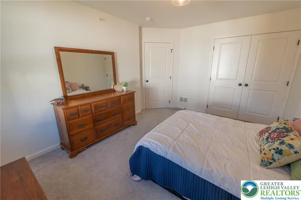 a bedroom with a bed and a dresser in it
