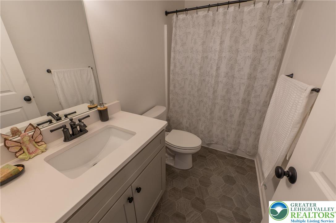 543 Long Street Emmaus, PA 18049 - Photo 16 of 18 a bathroom with a sink a toilet and a mirror