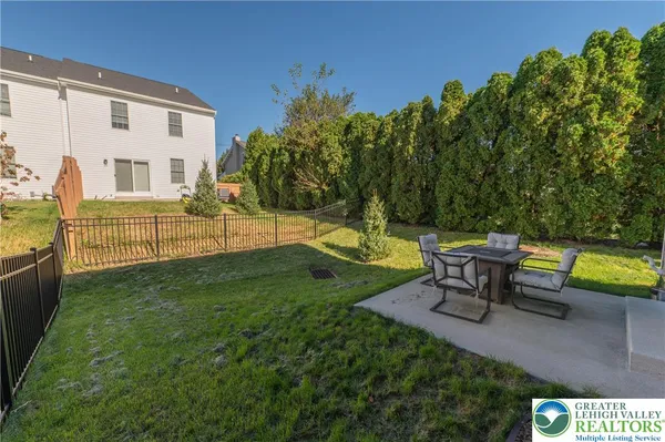 a view of a two chairs and table in the yard