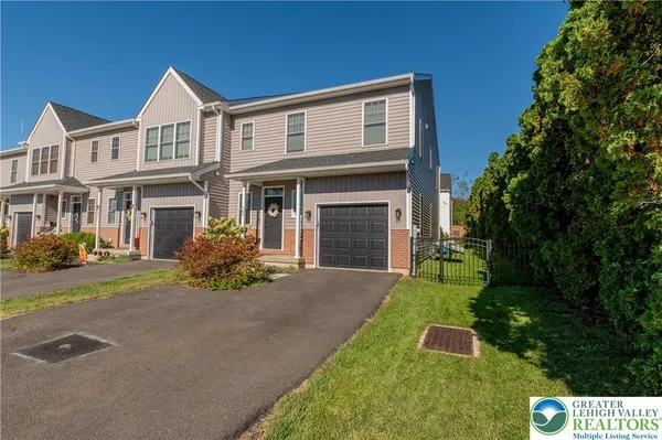 a front view of a house with a yard and garage