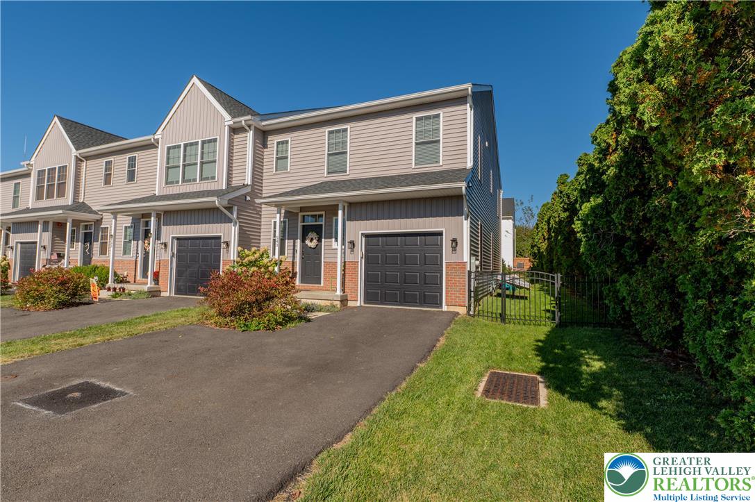 543 Long Street Emmaus, PA 18049 - Photo 2 of 18 a front view of a house with a yard and garage