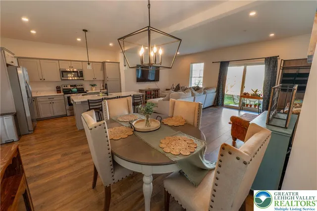 a large kitchen with a table and chairs