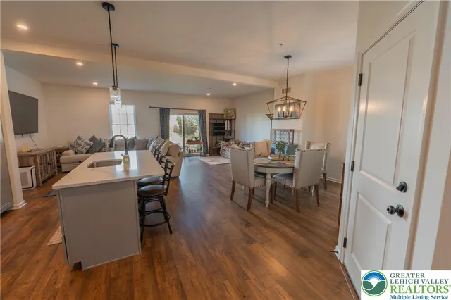 a living room with furniture dining table and a wooden floor