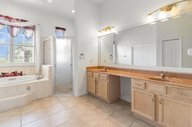 a spacious bathroom with a sink double vanity and bathtub