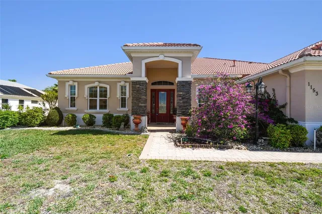 a front view of a house with garden
