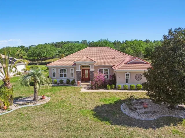 a aerial view of a house with a yard