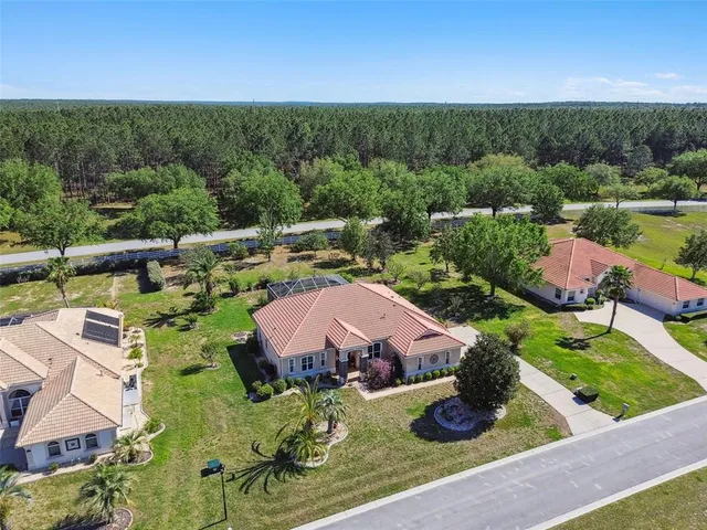 an aerial view of house with yard swimming pool and outdoor seating
