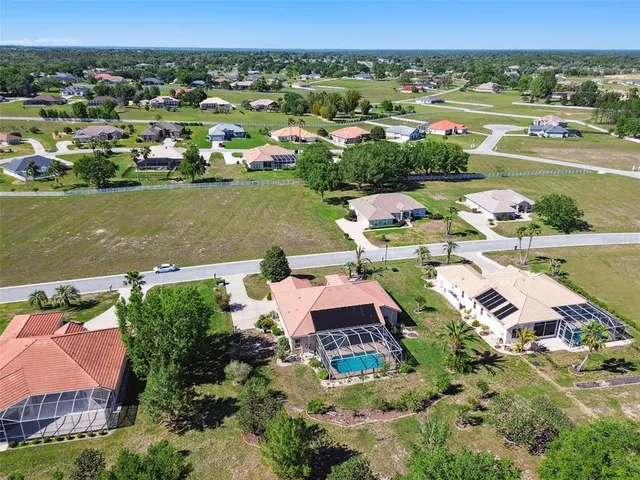 an aerial view of a house with a lake view