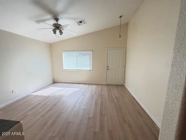 wooden floor in an empty room with a window