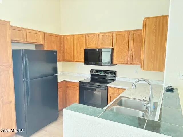 a kitchen with stainless steel appliances a refrigerator and a sink