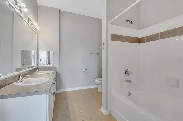 a bathroom with a tub sink and mirror