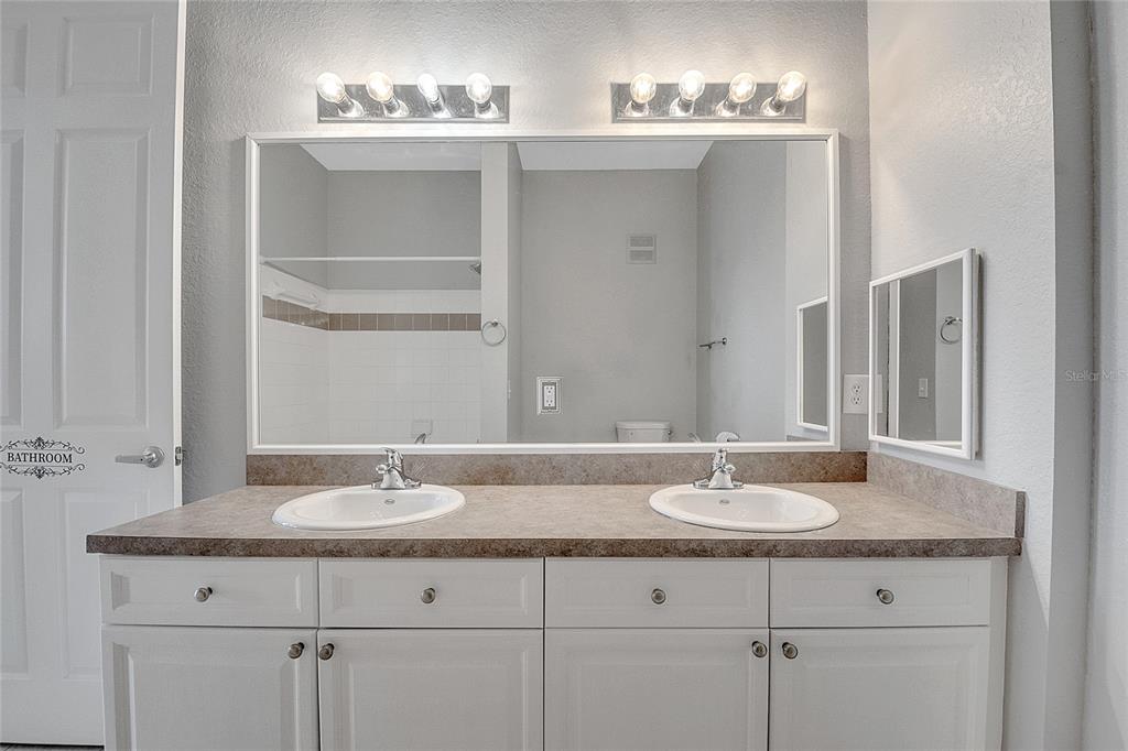 617 Terrace Ridge Circle, Unit 617 Davenport, FL 33896 - Photo 18 of 42 a bathroom with double sink and a mirror