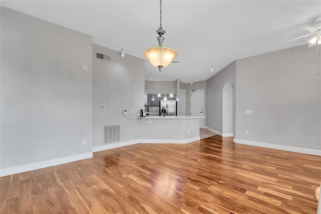 617 Terrace Ridge Circle, Unit 617 Davenport, FL 33896 - Photo 2 of 42 a view of a room with wooden floor and a ceiling fan