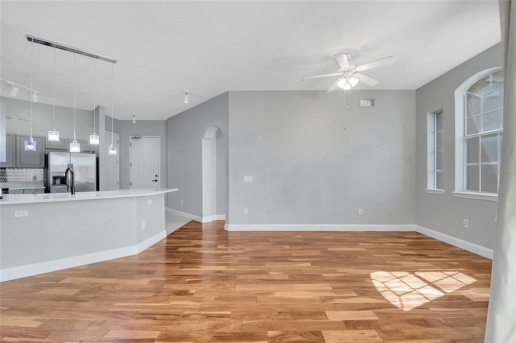 617 Terrace Ridge Circle, Unit 617 Davenport, FL 33896 - Photo 21 of 42 a view of a kitchen with kitchen island stainless steel appliances wooden floor and window