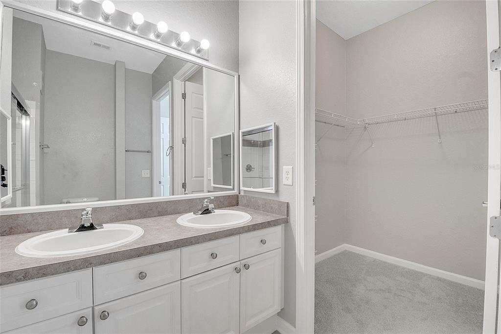 617 Terrace Ridge Circle, Unit 617 Davenport, FL 33896 - Photo 22 of 42 a bathroom with double sink and a mirror