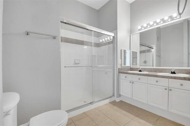 a bathroom with a toilet sink and shower