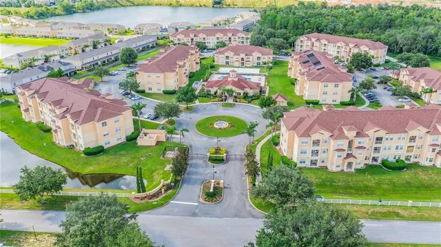 an aerial view of multiple houses with yard