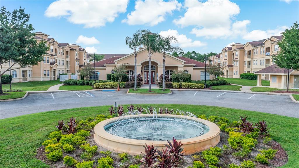 617 Terrace Ridge Circle, Unit 617 Davenport, FL 33896 - Photo 41 of 42 a view of a swimming pool with a house in the background