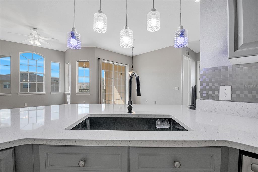 617 Terrace Ridge Circle, Unit 617 Davenport, FL 33896 - Photo 8 of 42 a view of a kitchen with a sink and chandelier