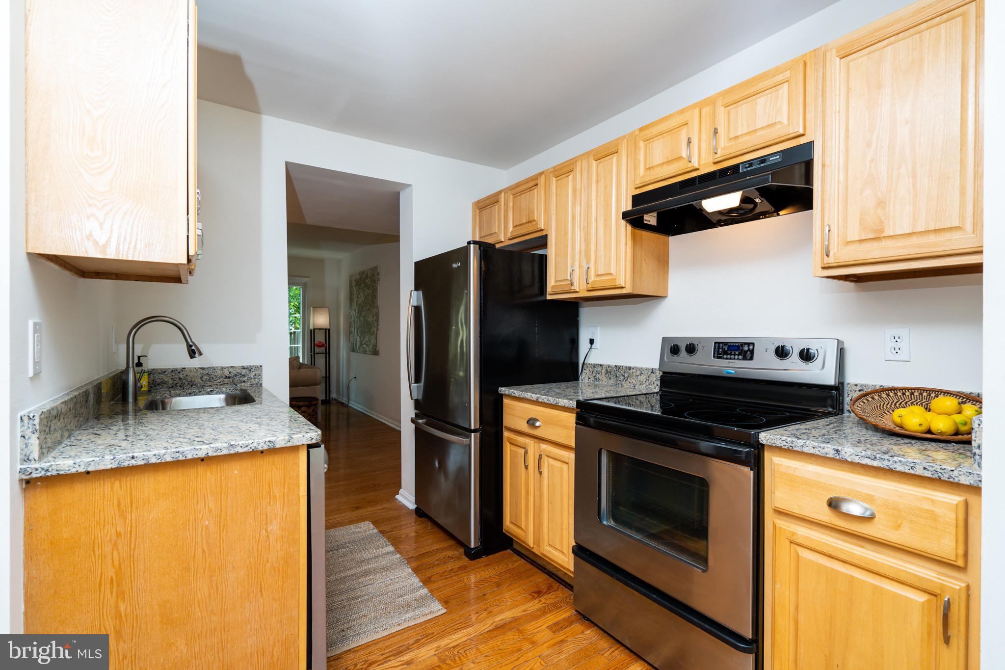 6490 Franconia Road Springfield, VA 22150 - Photo 11 of 34 a kitchen with stainless steel appliances granite countertop a sink stove and refrigerator
