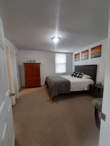 a bedroom with bed and window