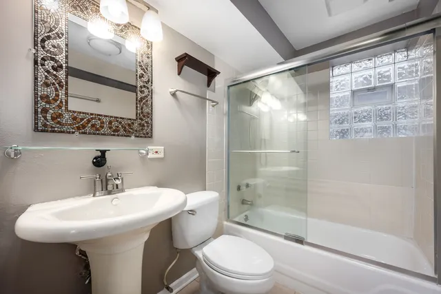 a bathroom with a sink toilet and shower
