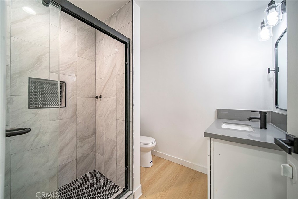 425 North Raymond Avenue Pasadena, CA 91103 - Photo 14 of 38 a bathroom with a granite countertop sink toilet and shower