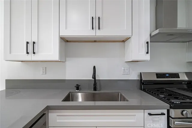 a kitchen with a sink and cabinets