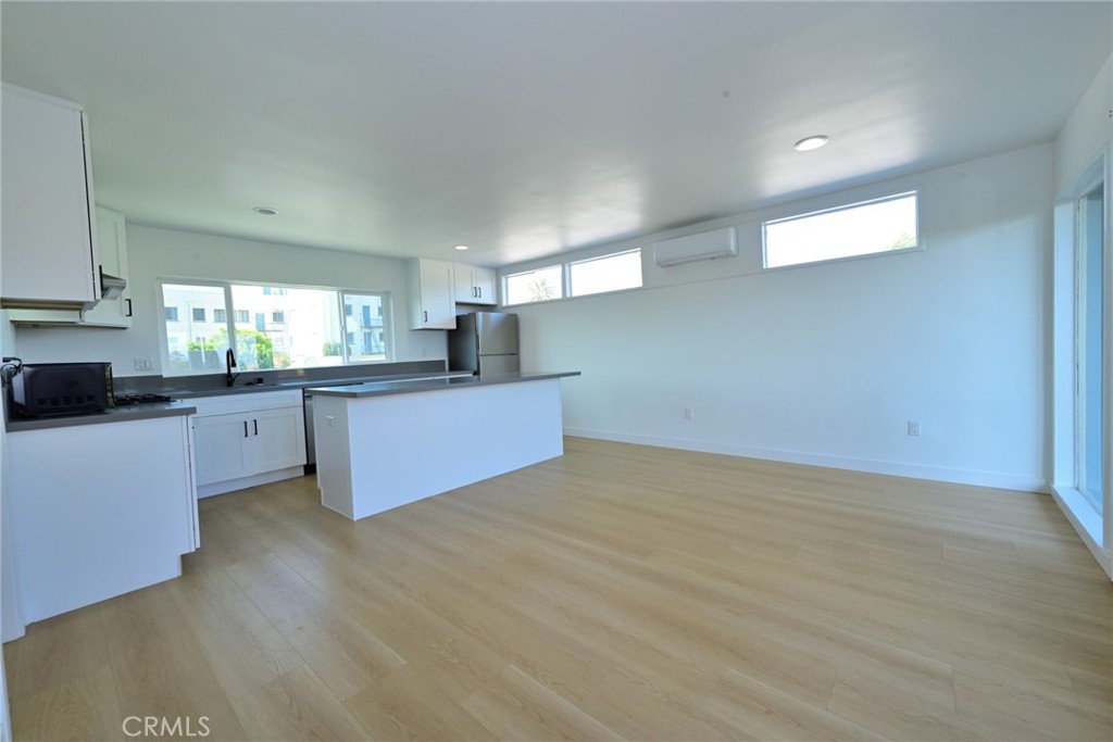 425 North Raymond Avenue Pasadena, CA 91103 - Photo 26 of 38 a large kitchen with granite countertop a stove a sink dishwasher and a white countertops with wooden floor