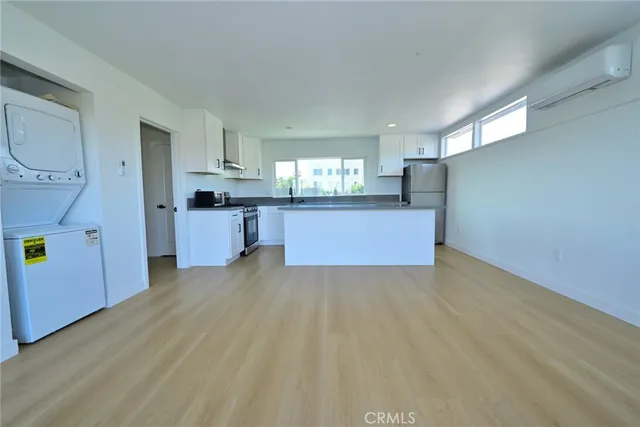 a view of a kitchen with a sink cabinets and wooden floor