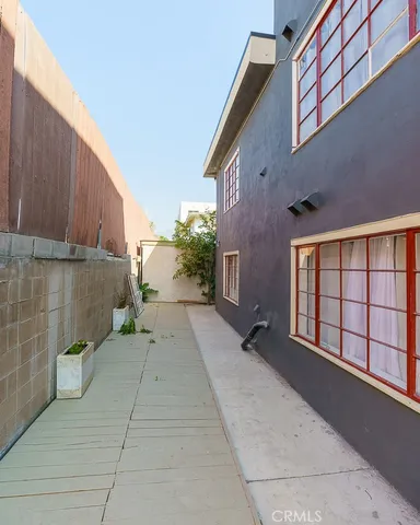 a view of a street with potted plants