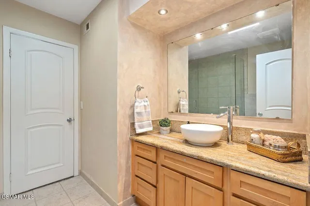 a bathroom with a shower a toilet and a sink