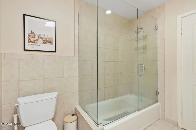 a view of backyard with a chair under a large tree