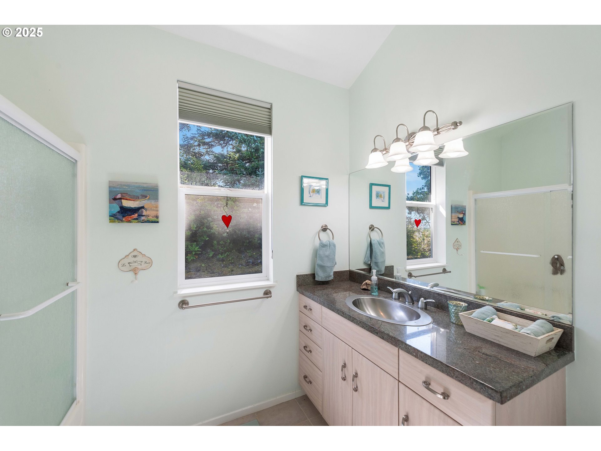 53 Shoreline Drive Florence, OR 97439 - Photo 11 of 36 a bathroom with a sink a large mirror and a window