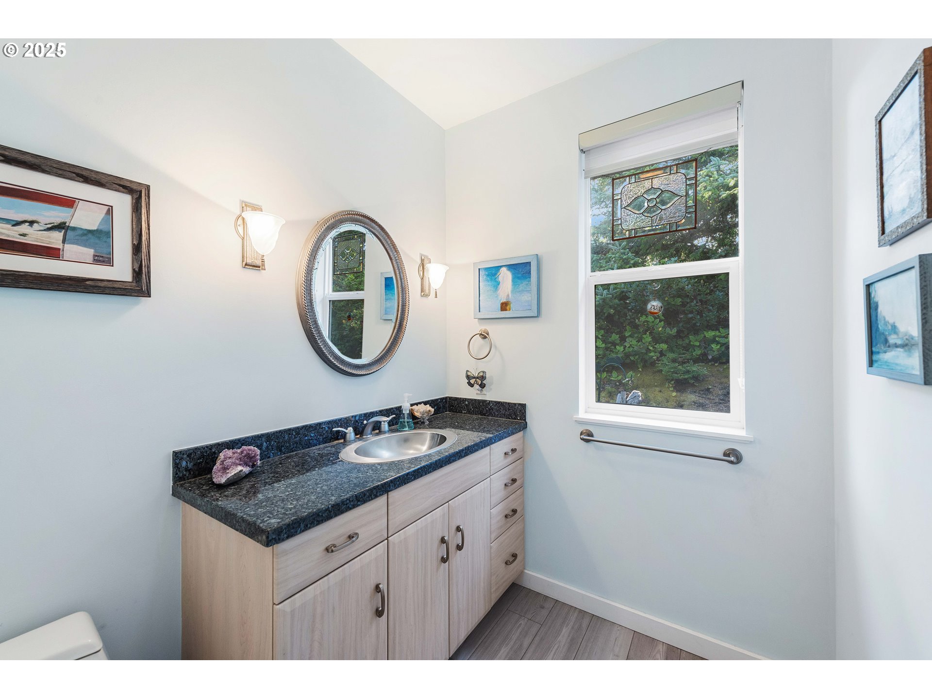 53 Shoreline Drive Florence, OR 97439 - Photo 12 of 36 a bathroom with a granite countertop sink and a mirror