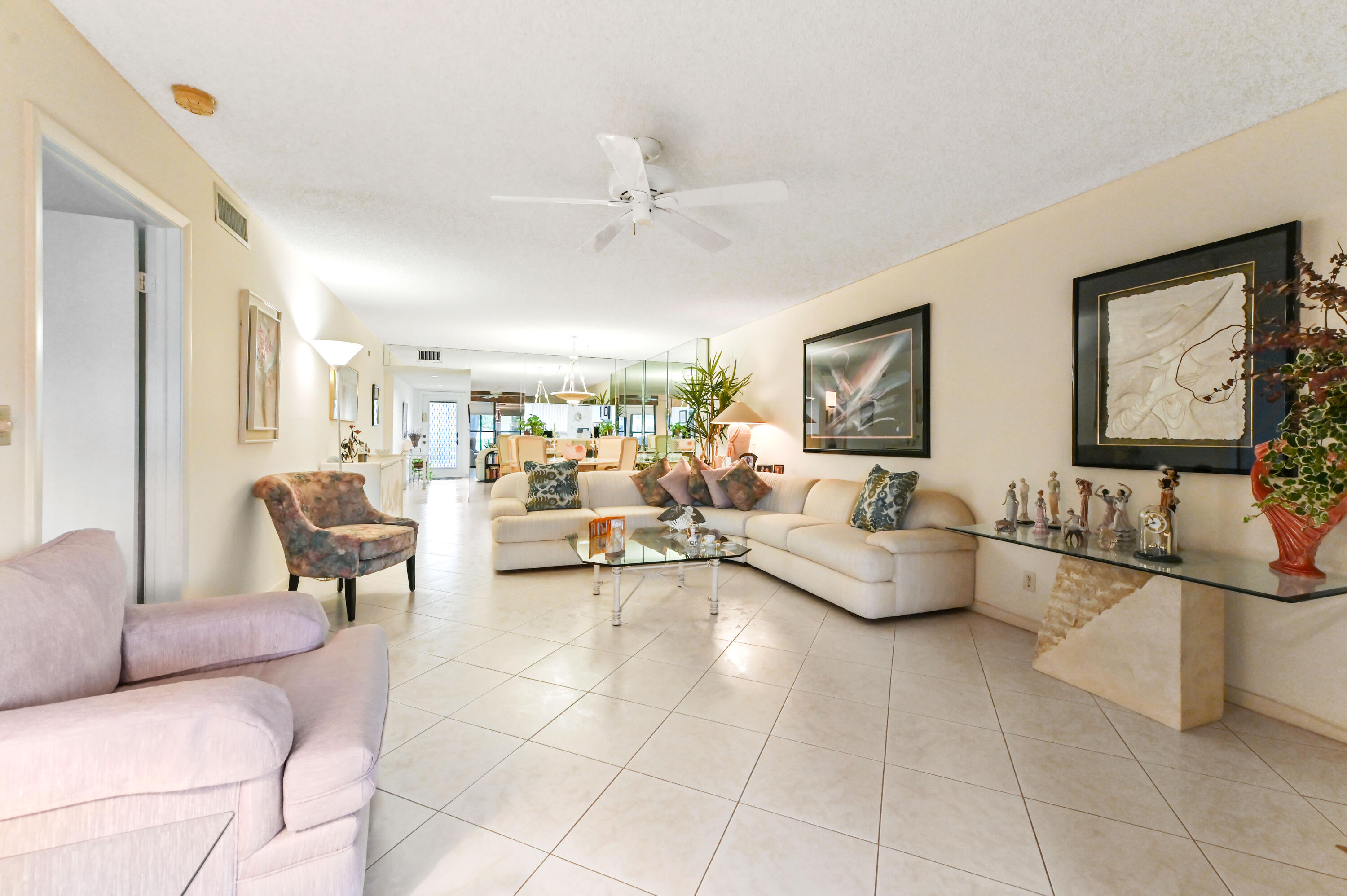 15074 Witney Road, Unit 107 Delray Beach, FL 33484 - Photo 12 of 60 a living room with furniture and a table