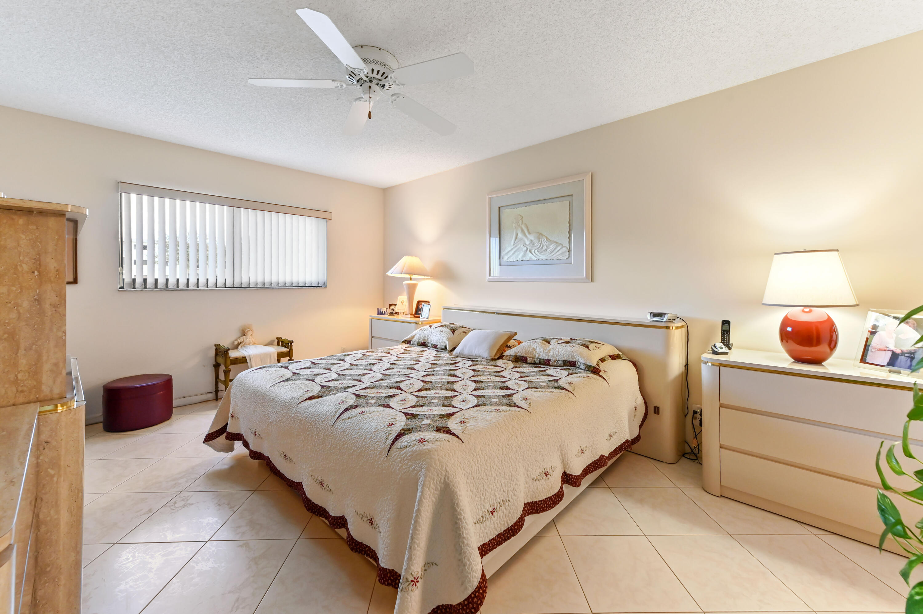15074 Witney Road, Unit 107 Delray Beach, FL 33484 - Photo 19 of 60 a bedroom with a bed and a painting on the wall