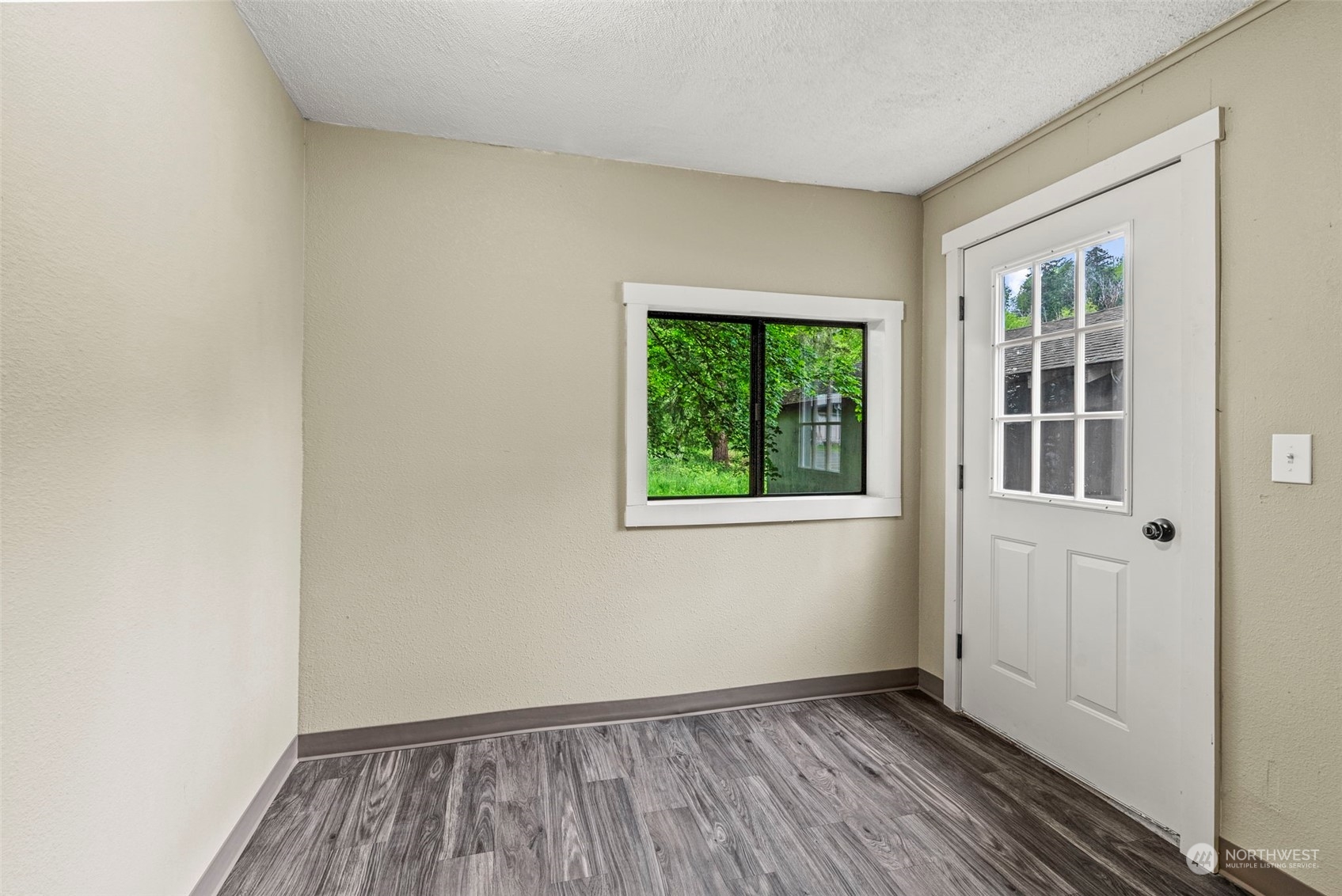 259 Stowell Road Salkum, WA 98582 - Photo 13 of 19 a view of an empty room with wooden floor and a window