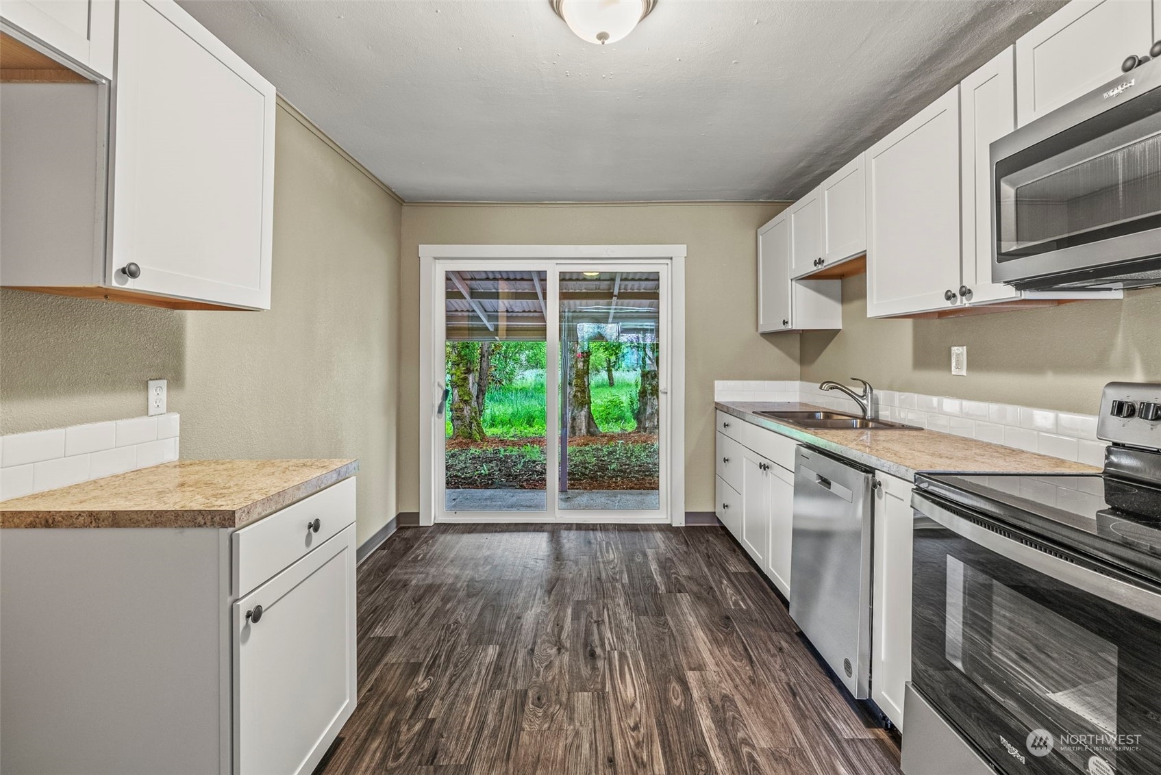 259 Stowell Road Salkum, WA 98582 - Photo 7 of 19 a kitchen with a sink stove top oven and cabinets