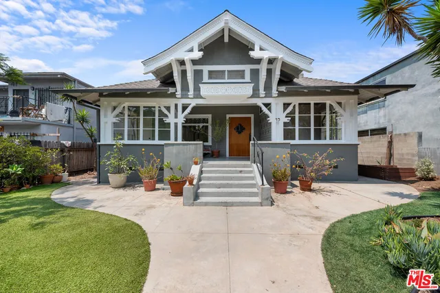 a front view of a house with a yard outdoor seating and barbeque oven