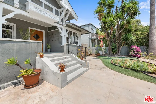 a view of a chair and tables in the balcony