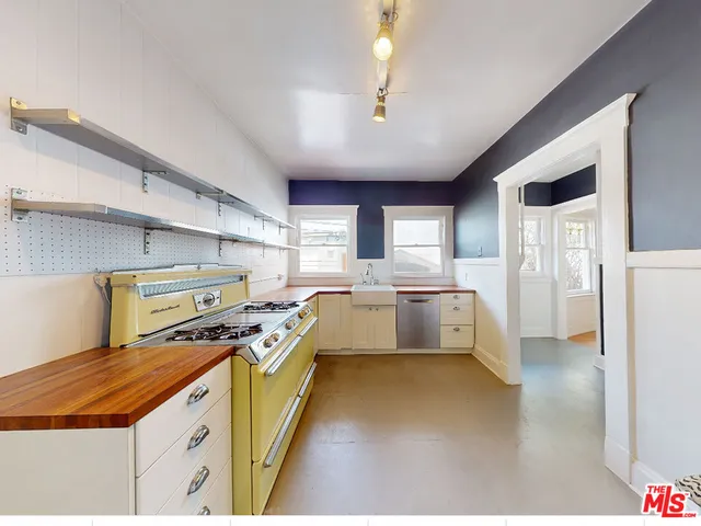 a kitchen with a stove a sink and a refrigerator