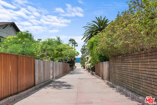 a view of small yard with wooden fence
