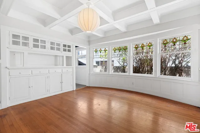 a view of a dining room with furniture large windows and wooden floor