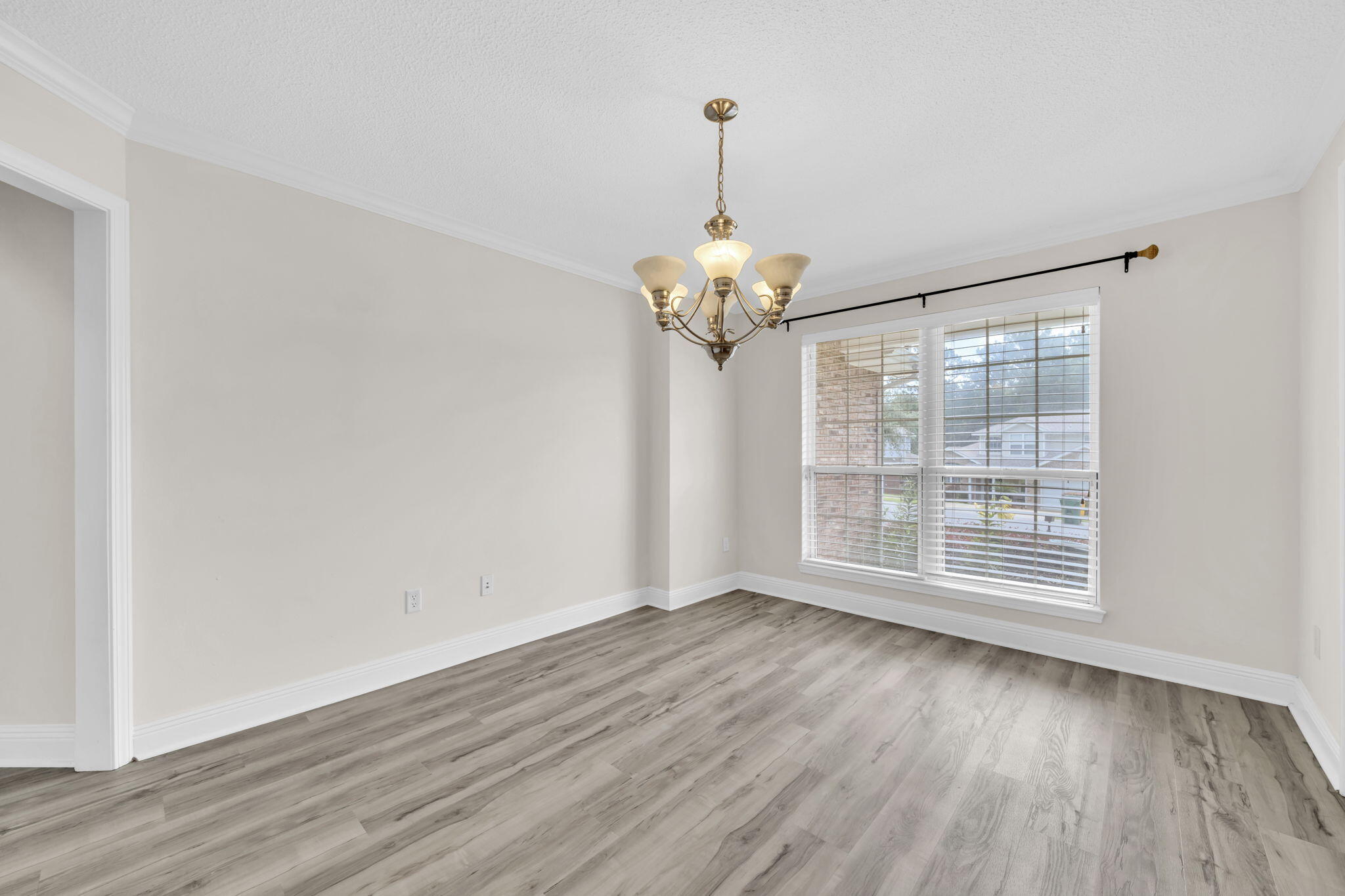 202 Gracie Lane Niceville, FL 32578 - Photo 11 of 47 a view of wooden floor and a chandelier in living room