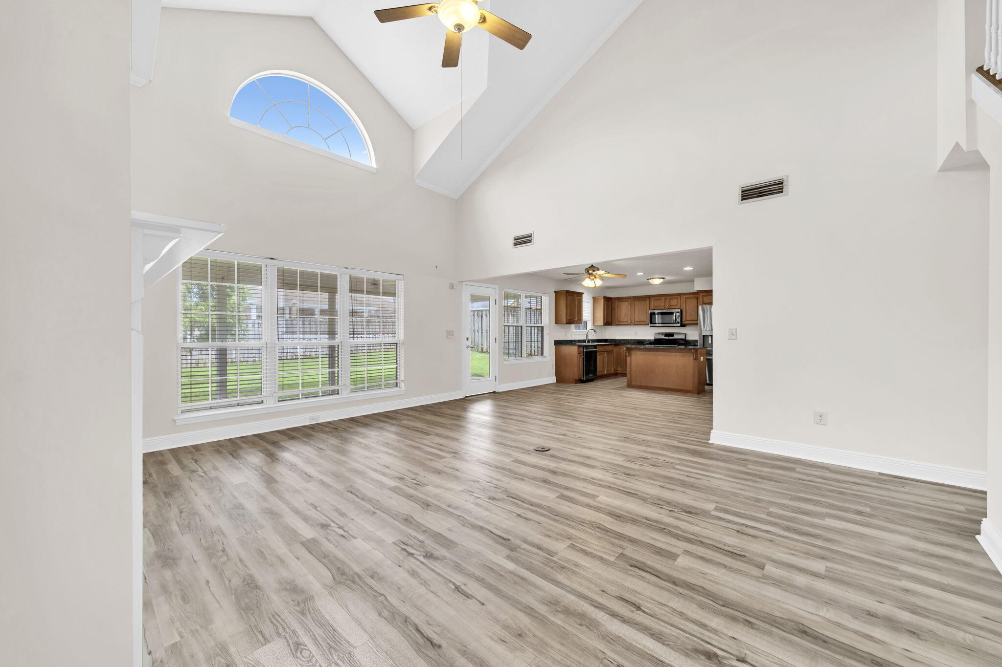 202 Gracie Lane Niceville, FL 32578 - Photo 13 of 47 a view of empty room with wooden floor and fan