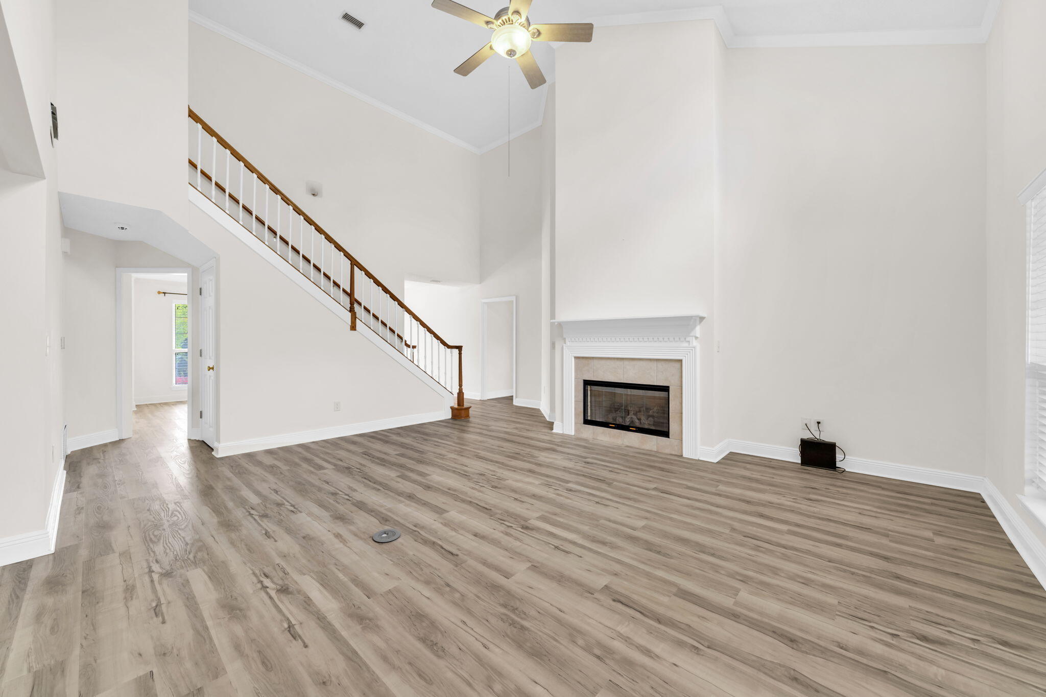 202 Gracie Lane Niceville, FL 32578 - Photo 16 of 47 a view of empty room with wooden floor and fireplace