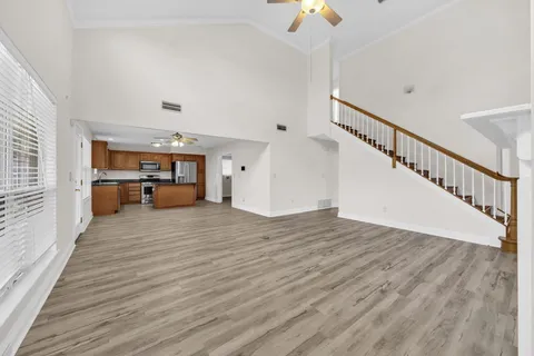 a view of livingroom with hardwood floor and a ceiling fan