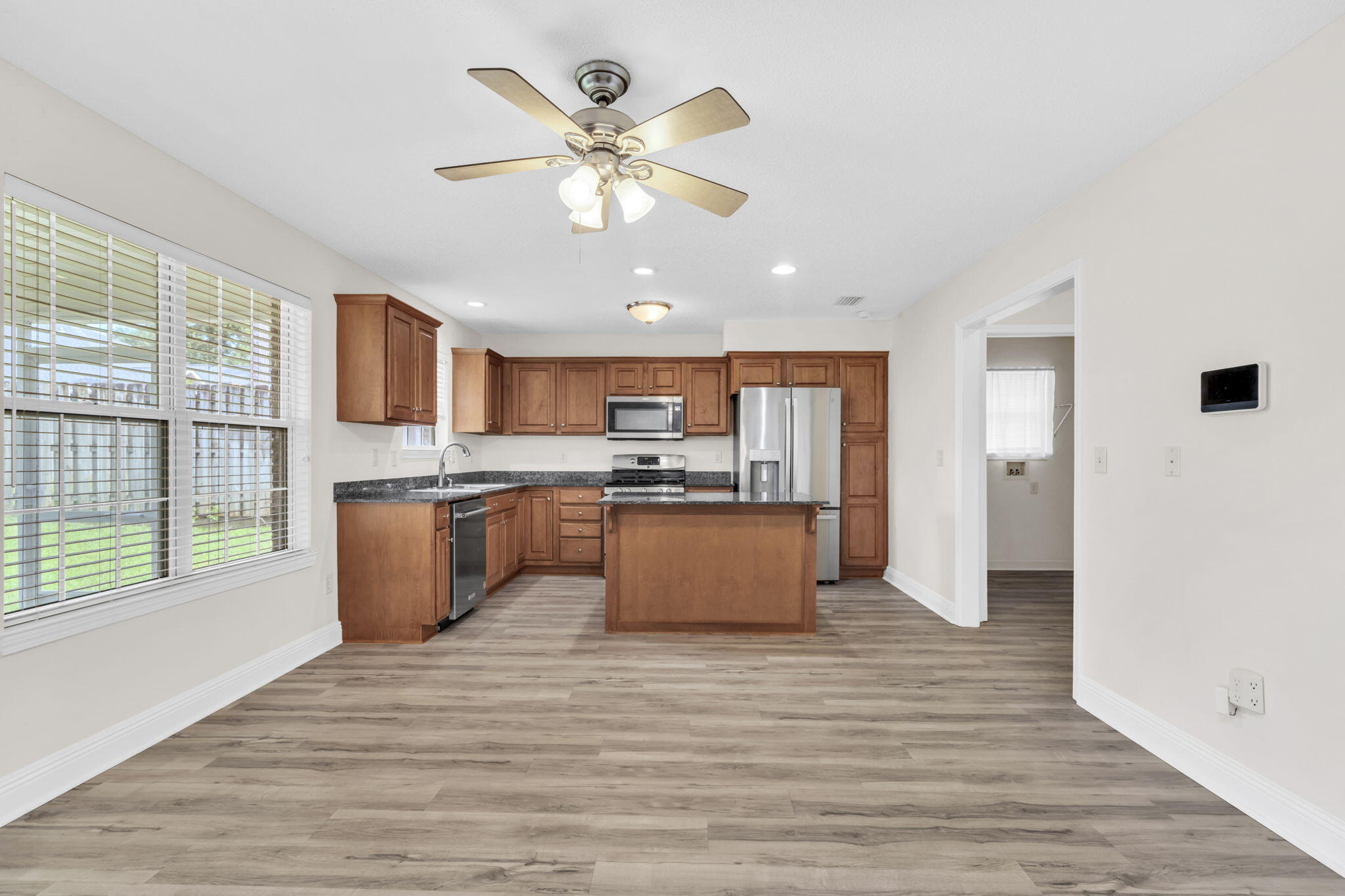 202 Gracie Lane Niceville, FL 32578 - Photo 18 of 47 a large kitchen with stainless steel appliances kitchen island a large counter top and a wooden floors