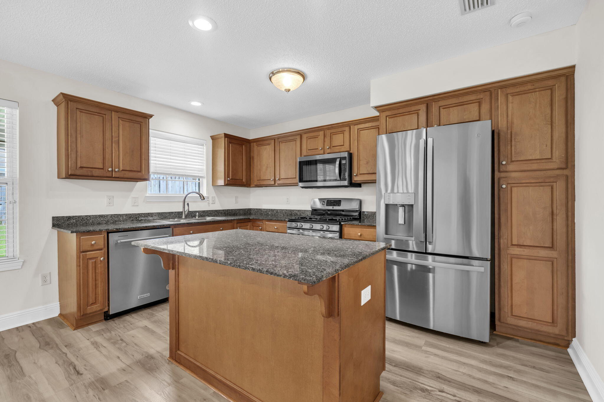 202 Gracie Lane Niceville, FL 32578 - Photo 22 of 47 a kitchen with stainless steel appliances granite countertop a refrigerator stove microwave and sink